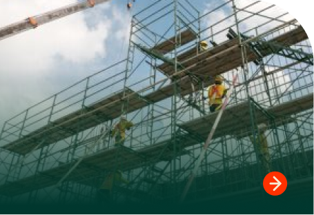 Workers using wood scaffold planks on construction scaffolding