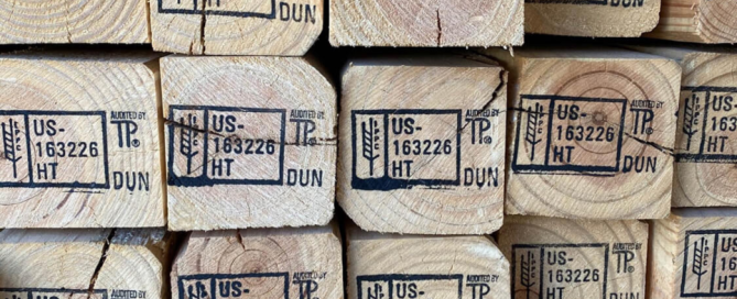 Close-up image of dunnage lumber with heat treatment and dunnage markers stamped in black.